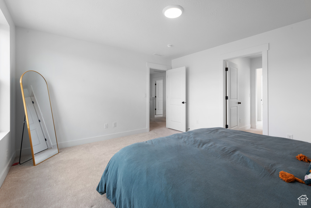 Carpeted bedroom with baseboards