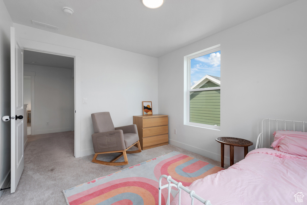 Bedroom with baseboards, light colored carpet, and visible vents