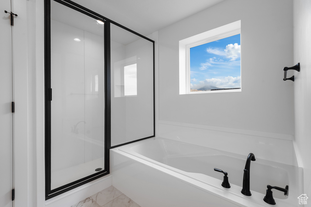 Full bathroom with a shower stall, a bath, and marble finish floor