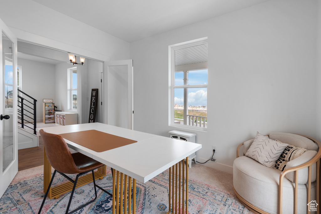 Office area featuring plenty of natural light, baseboards, and an inviting chandelier