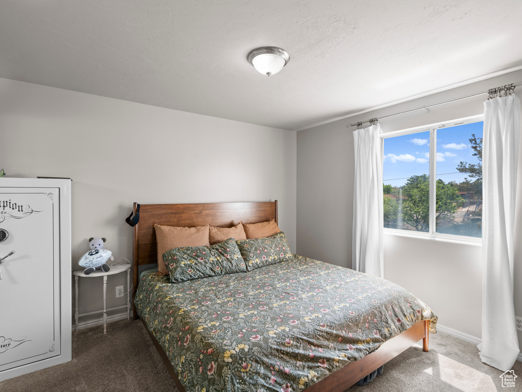 Carpeted bedroom with baseboards