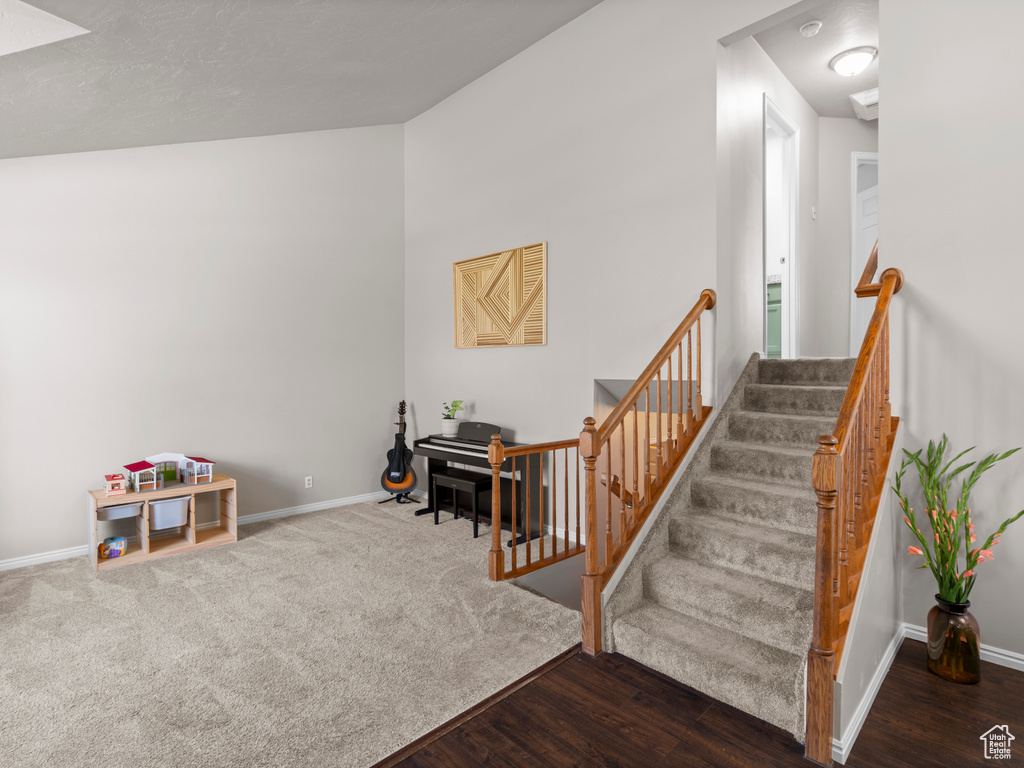 Stairway featuring baseboards and wood finished floors