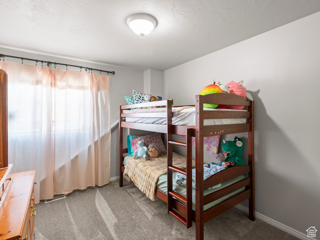 Carpeted bedroom featuring baseboards