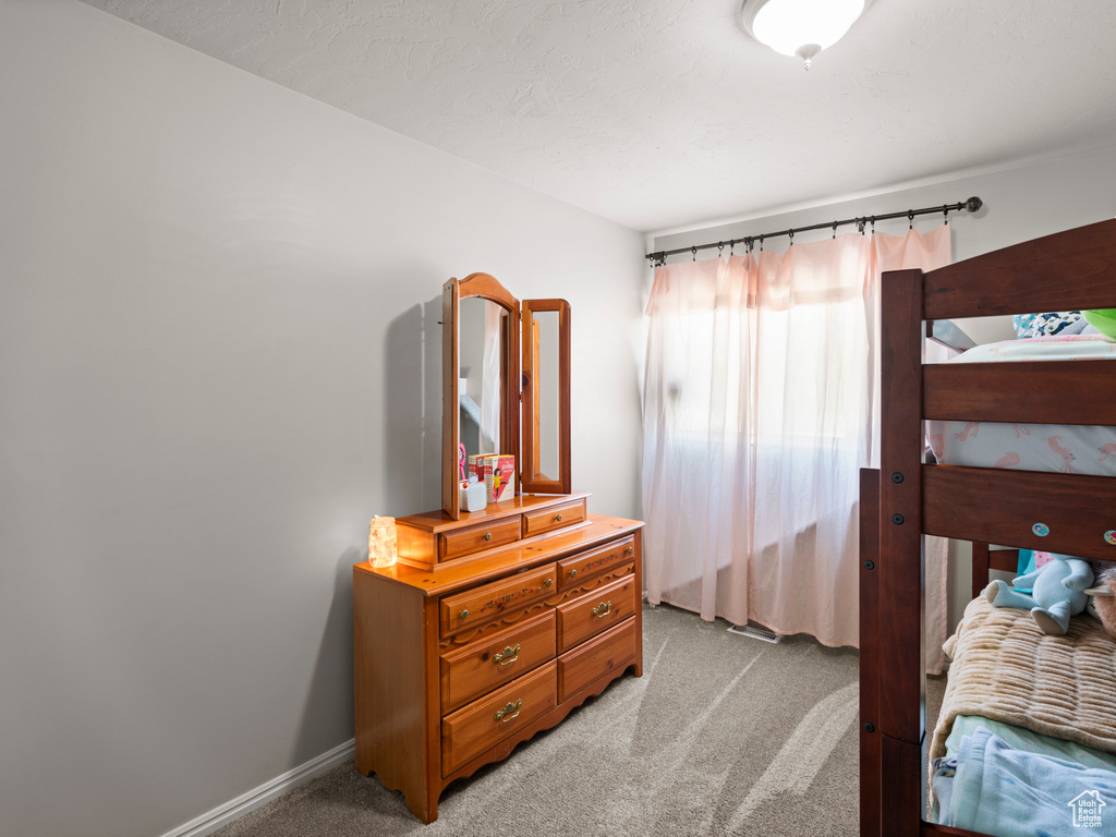 Bedroom featuring light colored carpet