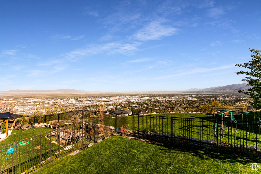 View of yard featuring fence and a mountain view