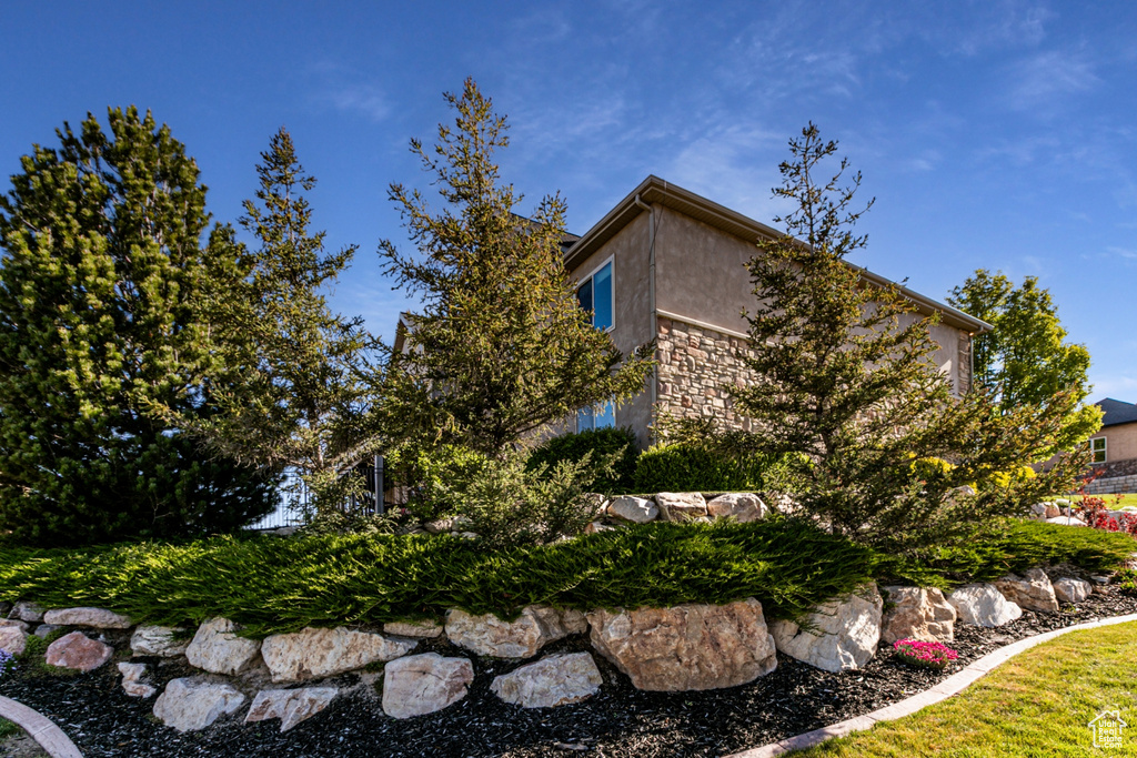View of home\\\'s exterior featuring stucco siding and stone siding