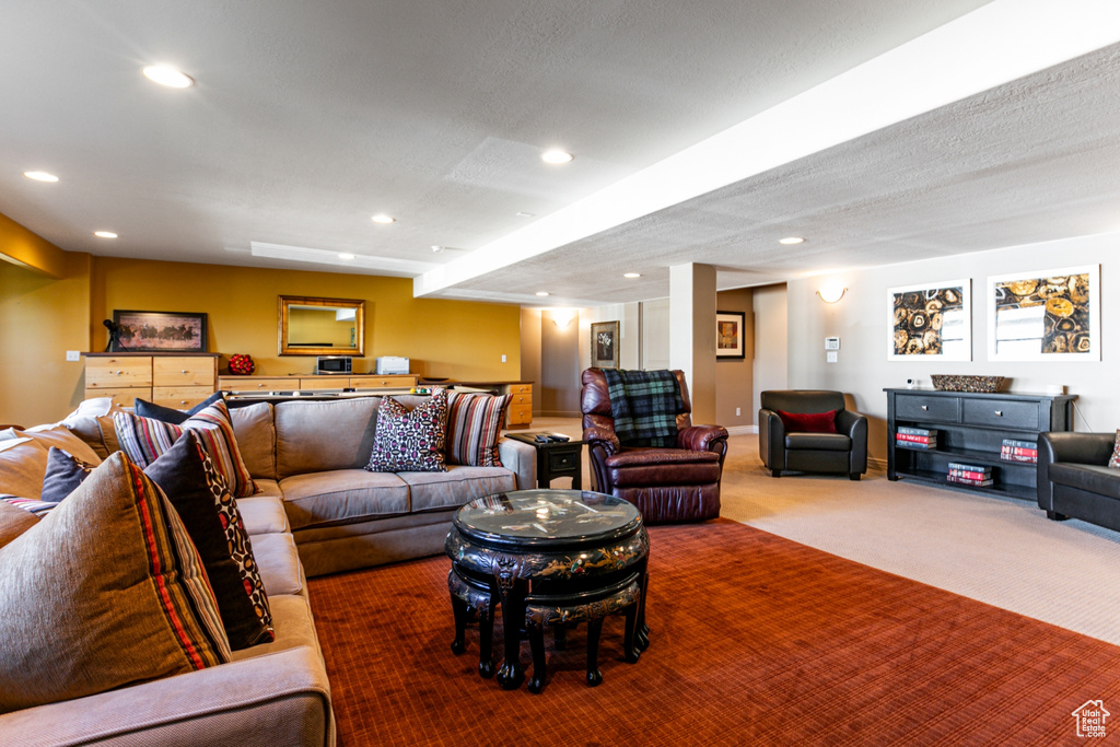 Carpeted living room featuring recessed lighting