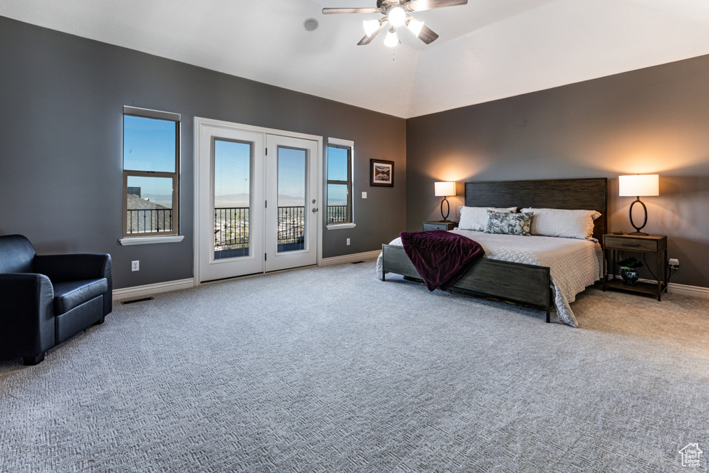 Carpeted bedroom featuring baseboards, access to outside, ceiling fan, and visible vents