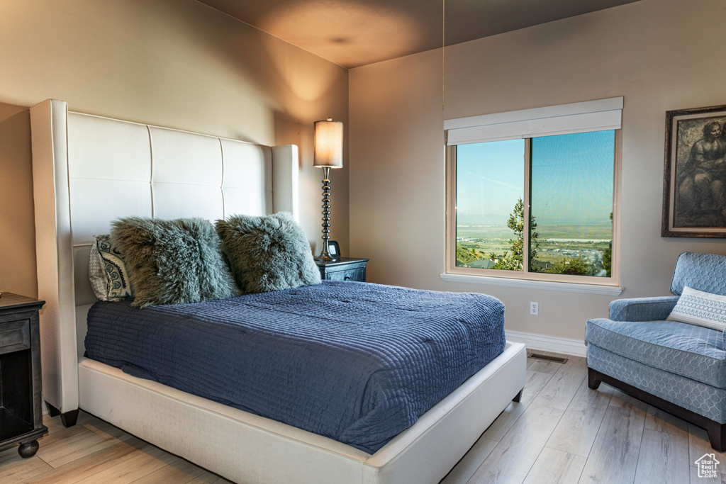 Bedroom featuring baseboards and wood finished floors