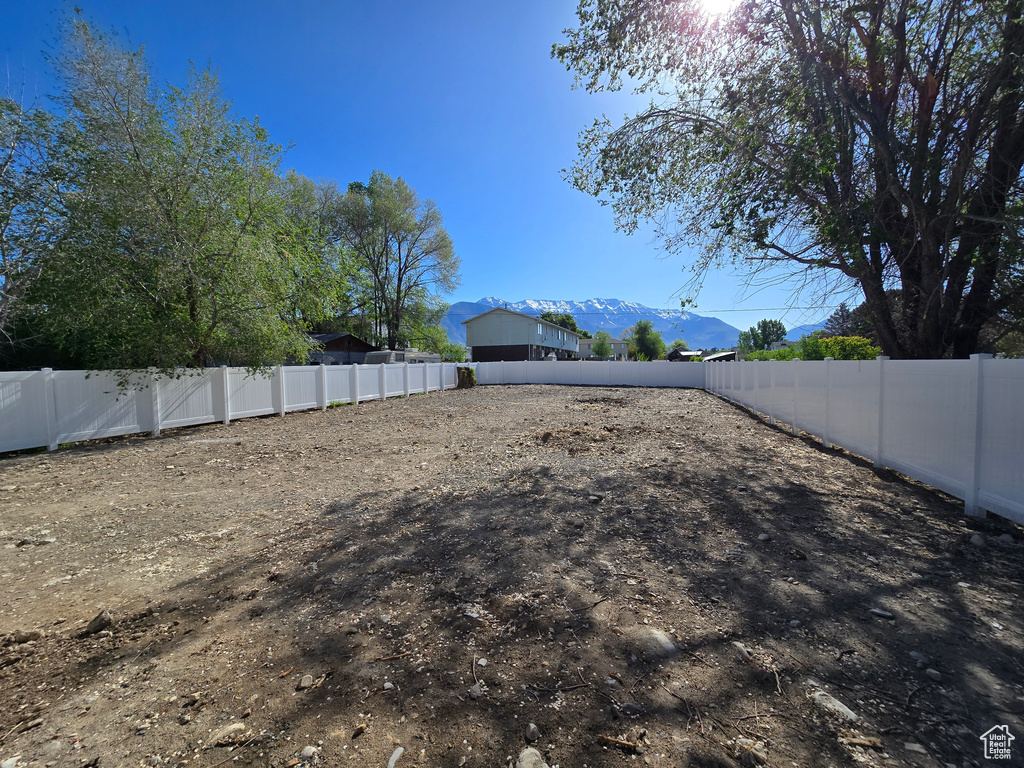 Fenced backyard with a mountain view