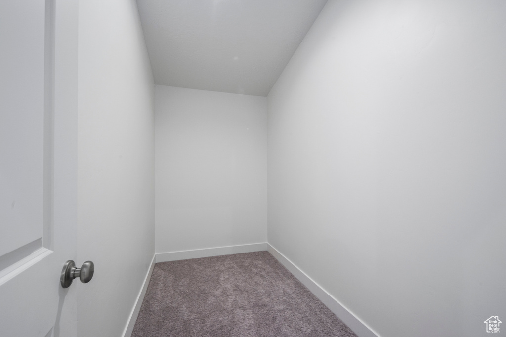 Carpeted empty room featuring baseboards
