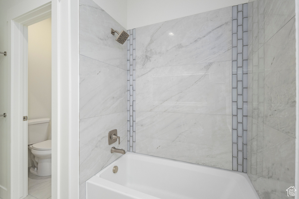Bathroom with bathing tub / shower combination and toilet