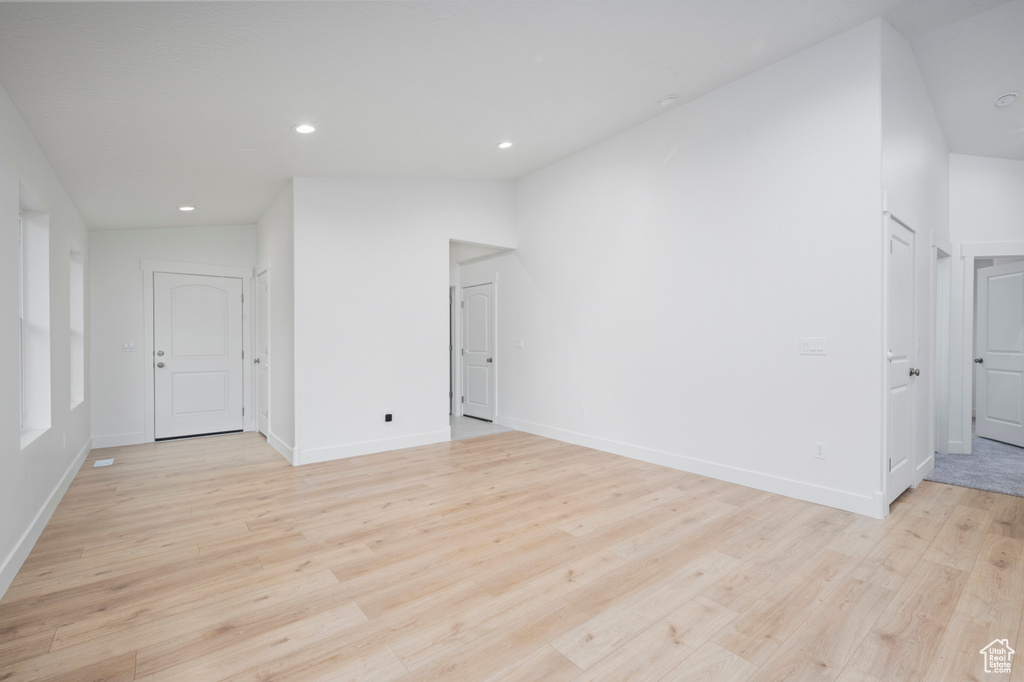Unfurnished room featuring recessed lighting, baseboards, and light wood finished floors