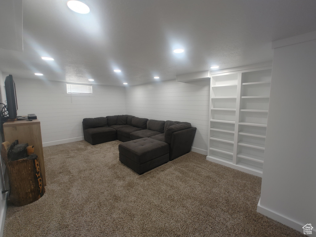 Carpeted living area featuring baseboards