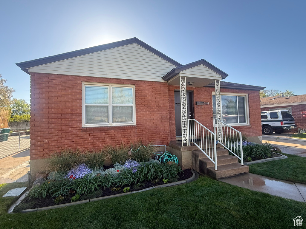 Bungalow-style home with brick siding