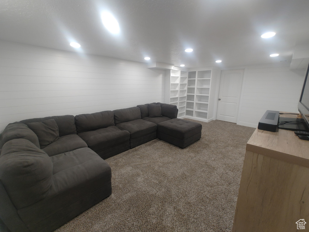 Living area with carpet floors, baseboards, and recessed lighting