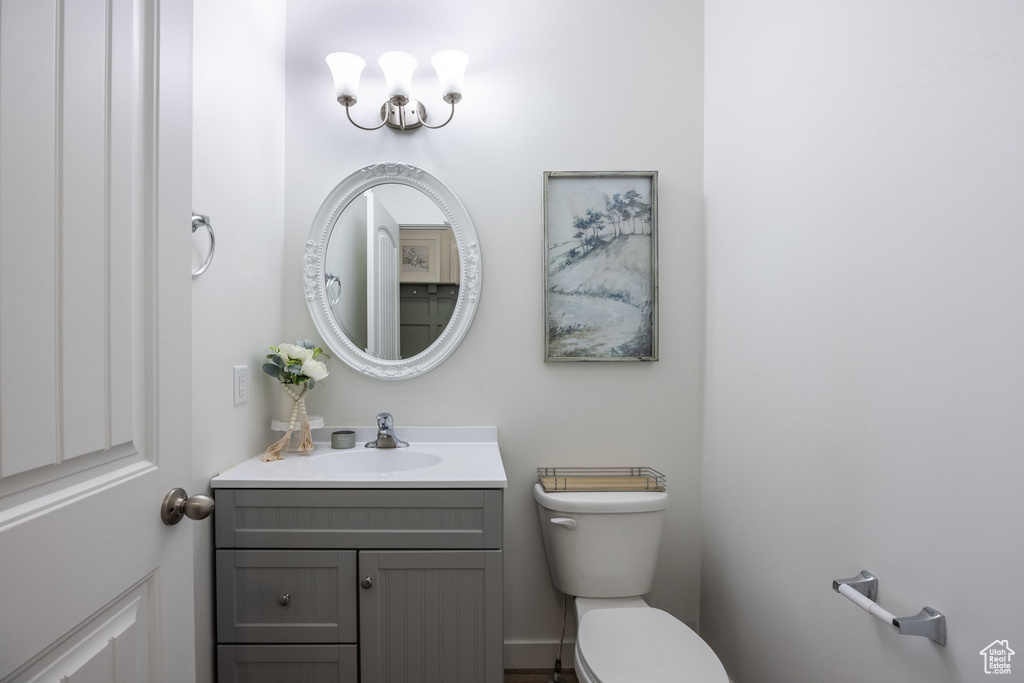 Half bathroom with toilet and vanity