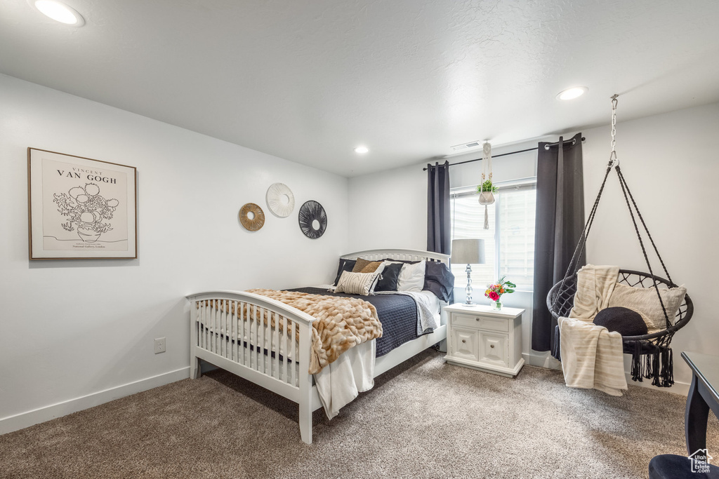 Carpeted bedroom with recessed lighting, baseboards, and visible vents
