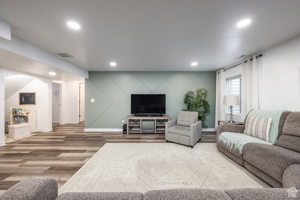 Living room featuring baseboards, recessed lighting, wood finished floors, and visible vents