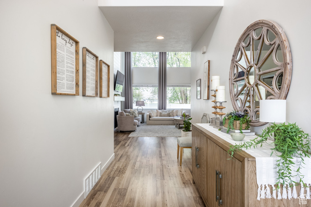 Hallway featuring recessed lighting, baseboards, light wood finished floors, and visible vents