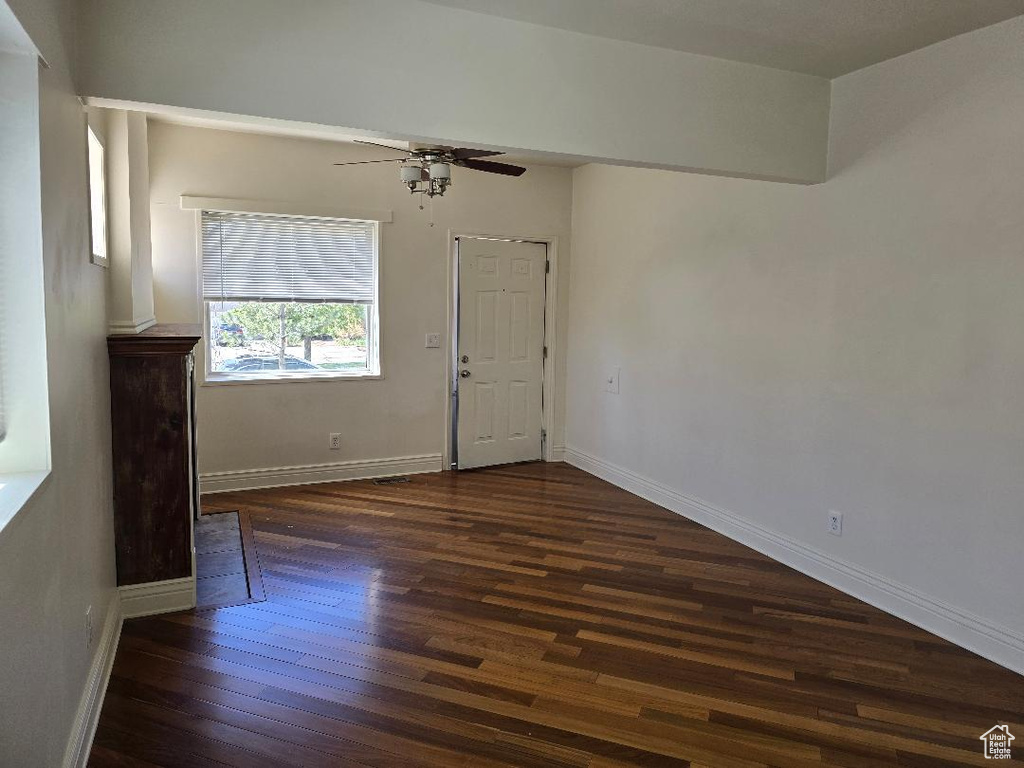 Interior space featuring baseboards, ceiling fan, and wood finished floors