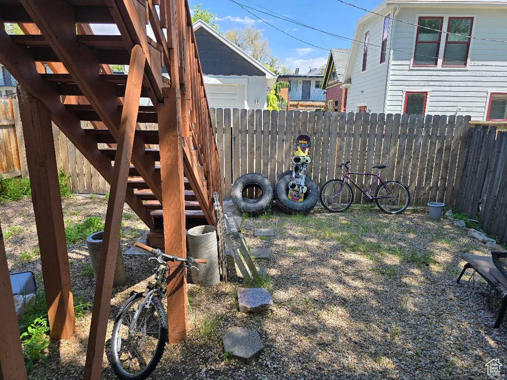 View of yard with a fenced backyard and stairs