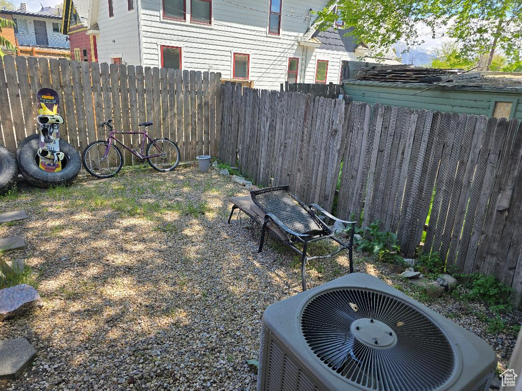 View of yard featuring fence and central AC unit
