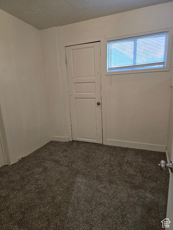 Empty room with baseboards and carpet