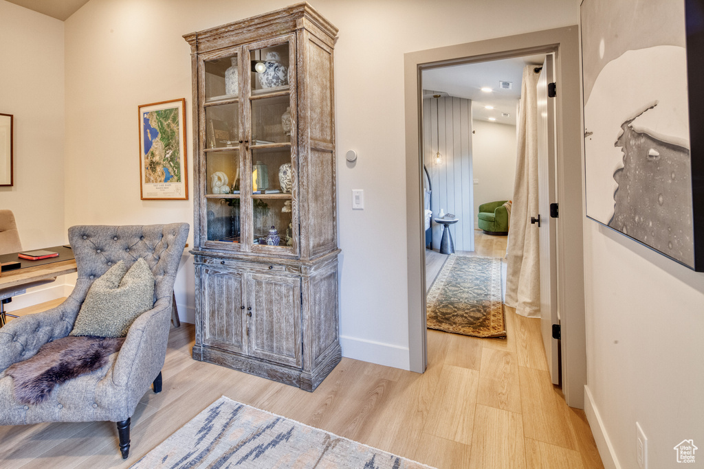 Sitting room with light wood-type flooring and baseboards