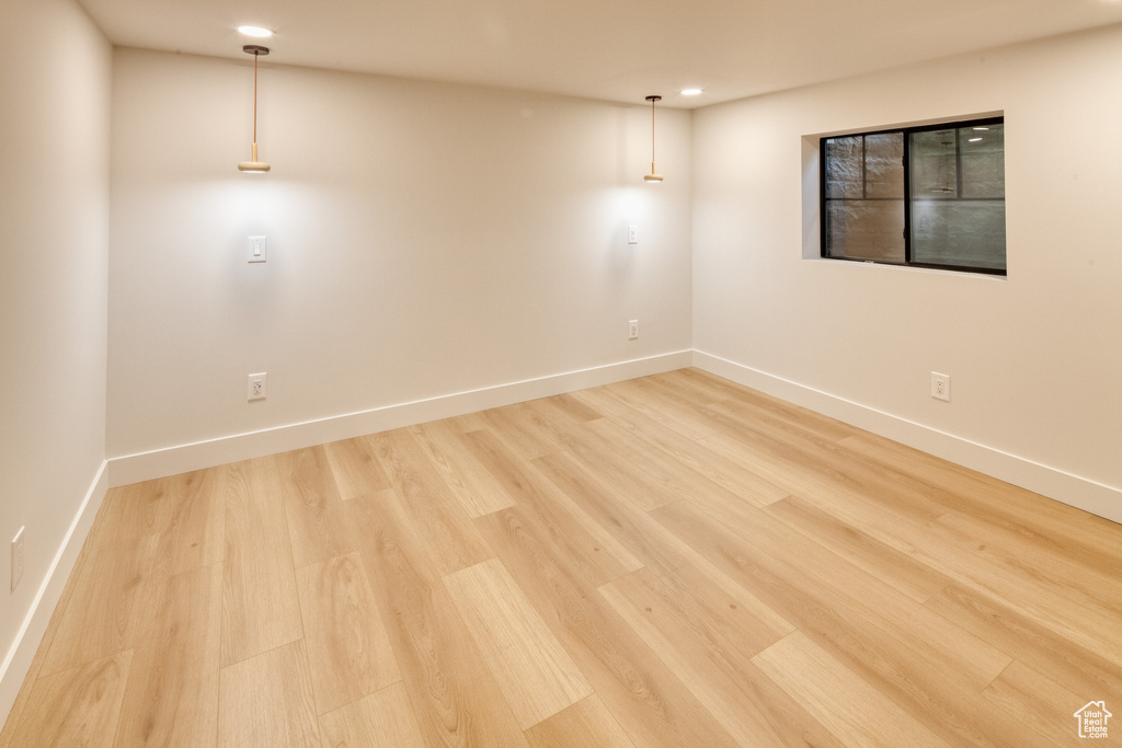 Empty room featuring recessed lighting, baseboards, and light wood-style flooring