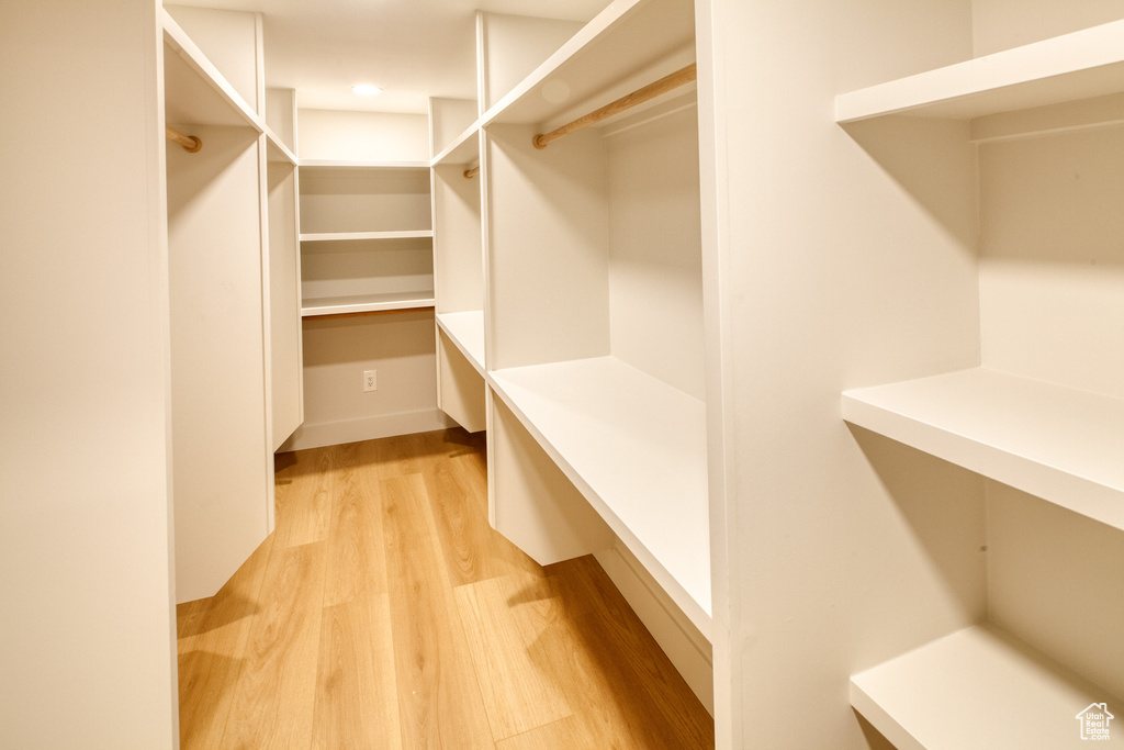 Spacious closet with light wood-style floors