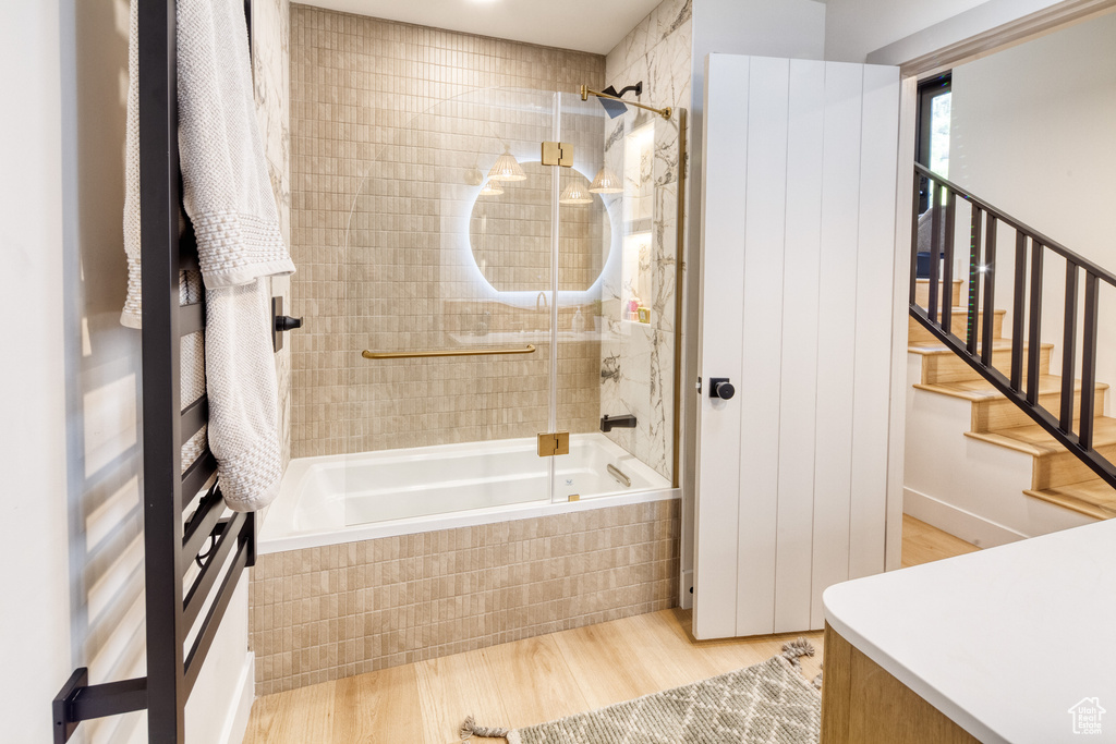 Bathroom featuring tiled shower / bath and wood finished floors