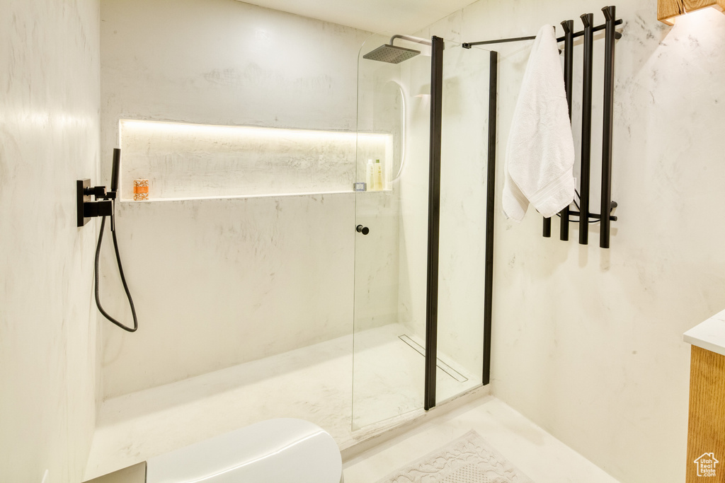 Bathroom featuring a marble finish shower