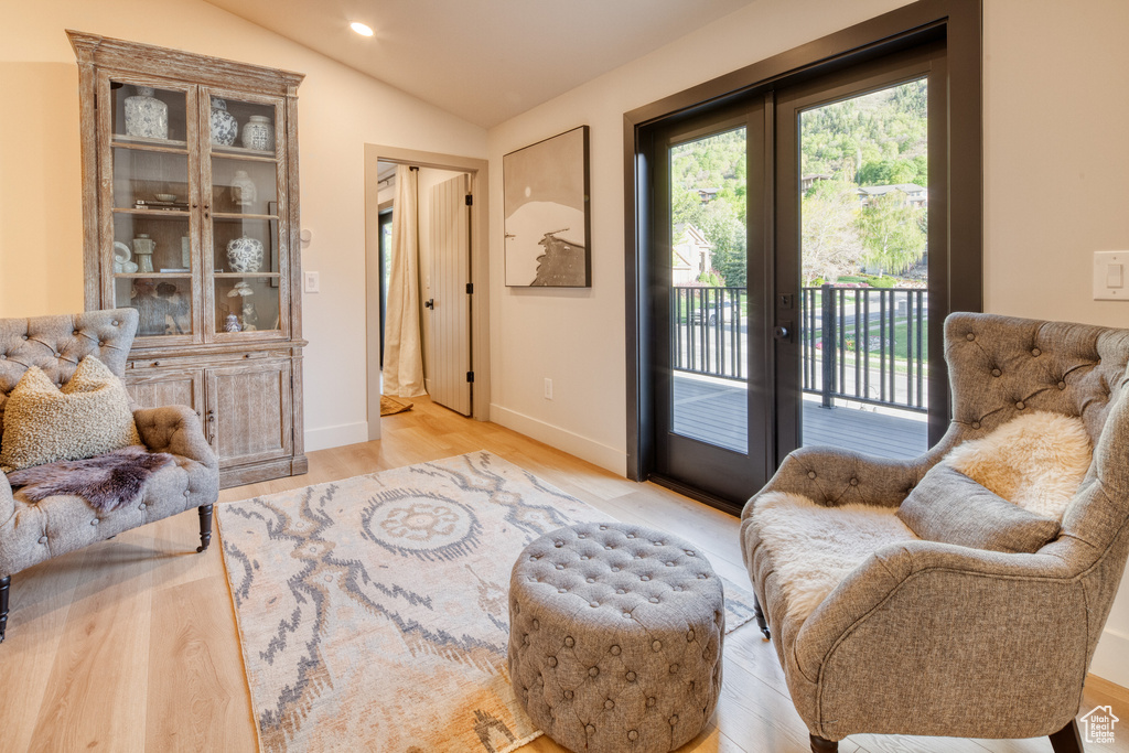 Sitting room featuring french doors, vaulted ceiling, baseboards, recessed lighting, and light wood-style flooring
