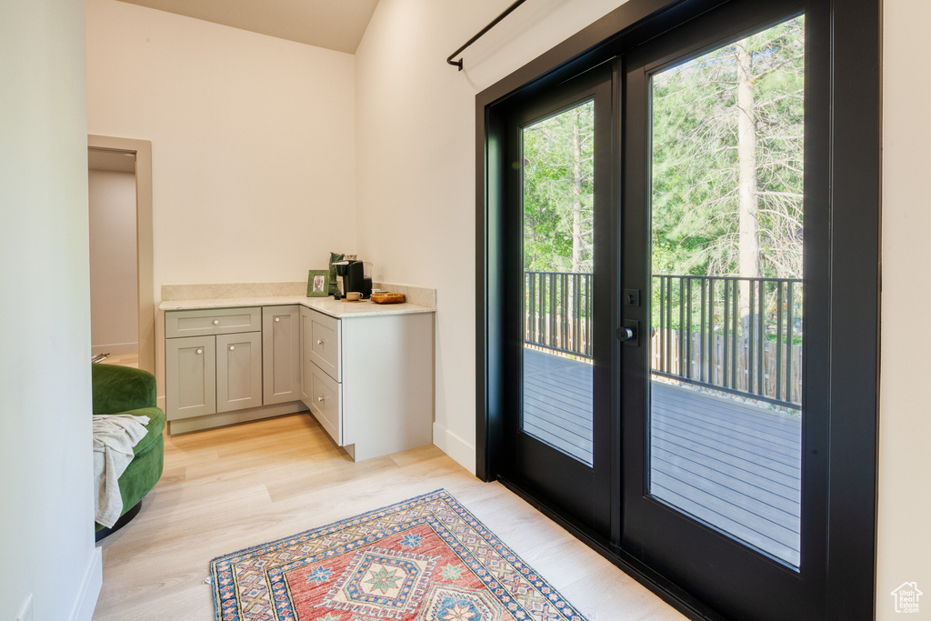 Entryway with french doors and light wood-style flooring