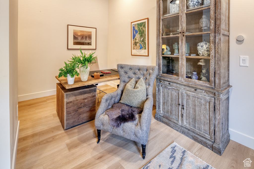 Living area with baseboards and wood finished floors