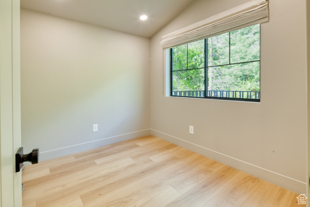 Empty room featuring recessed lighting, baseboards, and wood finished floors