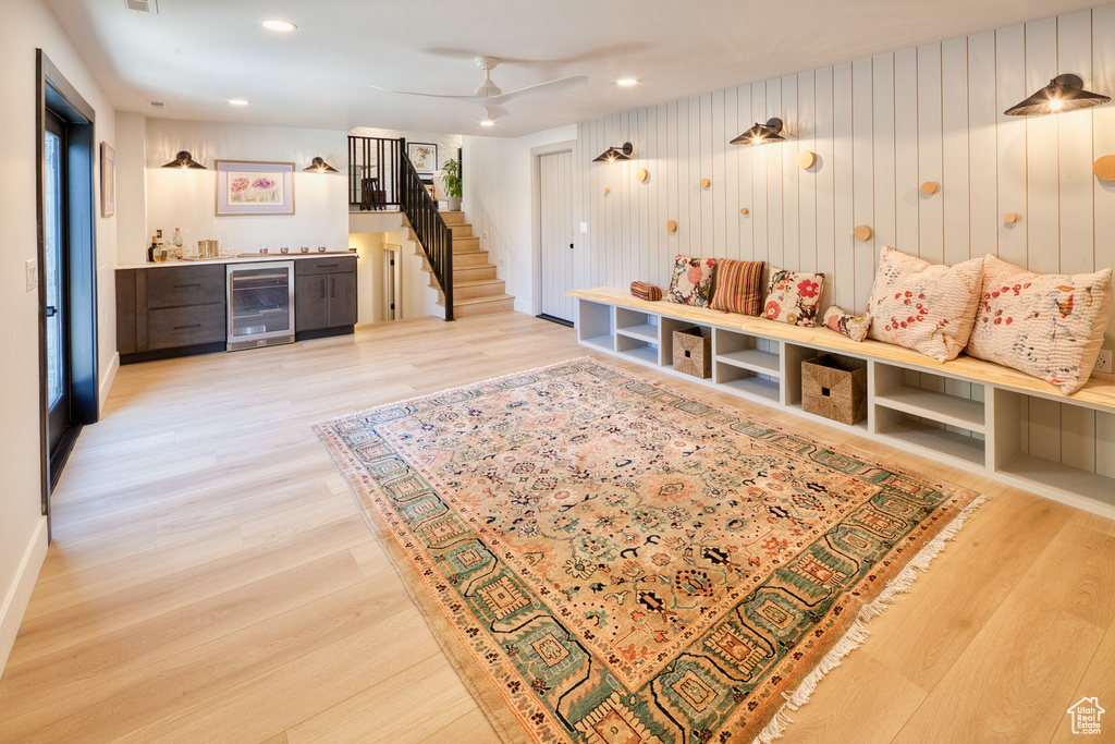 Mudroom featuring indoor bar, beverage cooler, a ceiling fan, and light wood finished floors