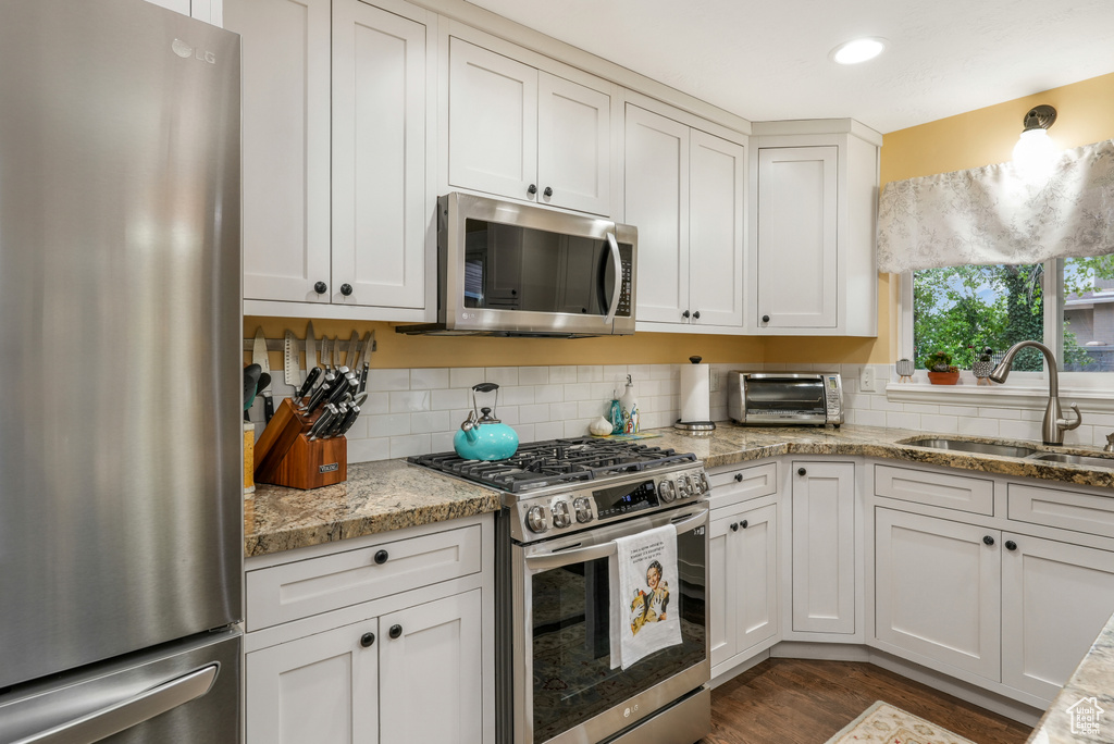 Kitchen with a sink, white cabinetry, appliances with stainless steel finishes, and a toaster