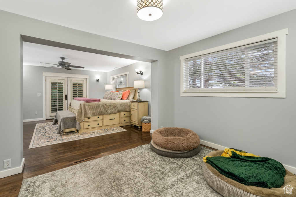 Bedroom with baseboards, visible vents, and wood finished floors