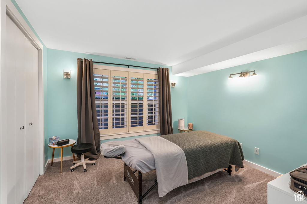 Bedroom featuring baseboards, carpet, and visible vents