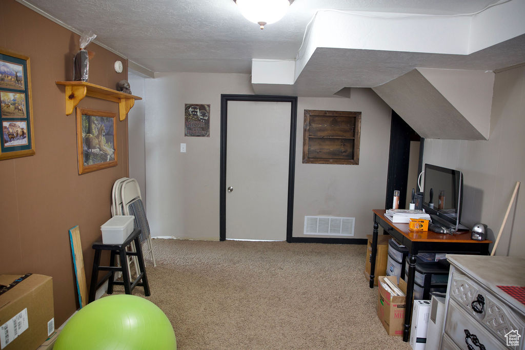 Interior space with a textured ceiling and visible vents