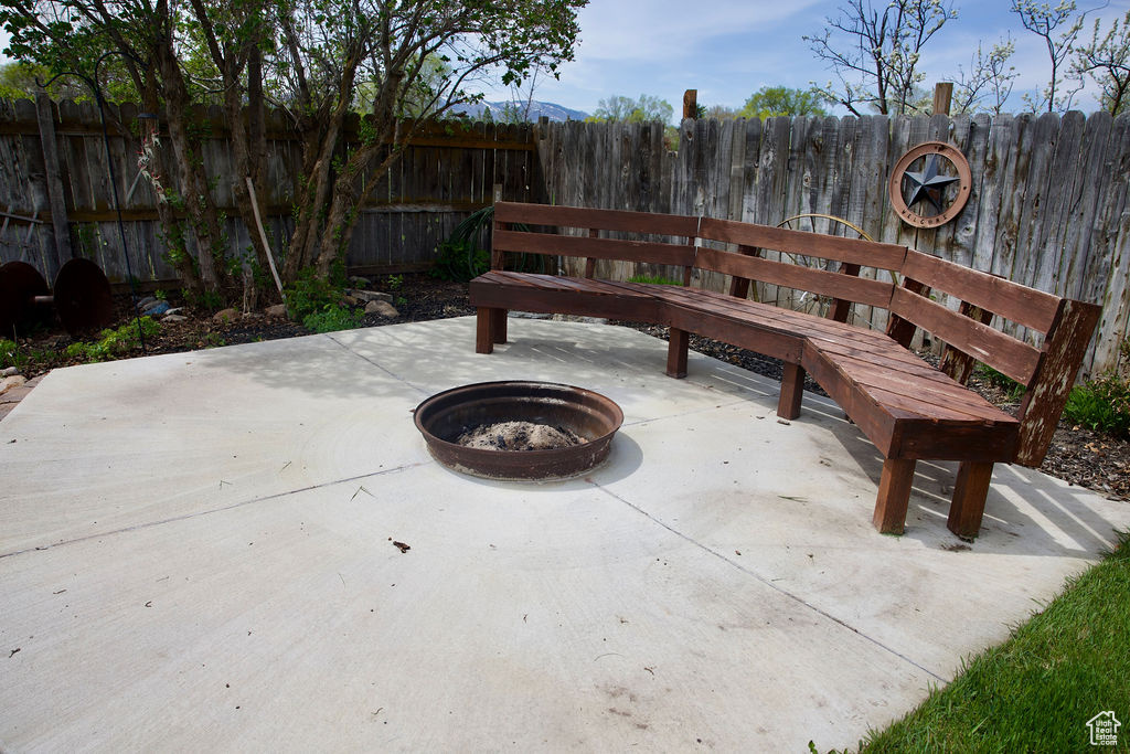 View of patio / terrace with fence and a fire pit