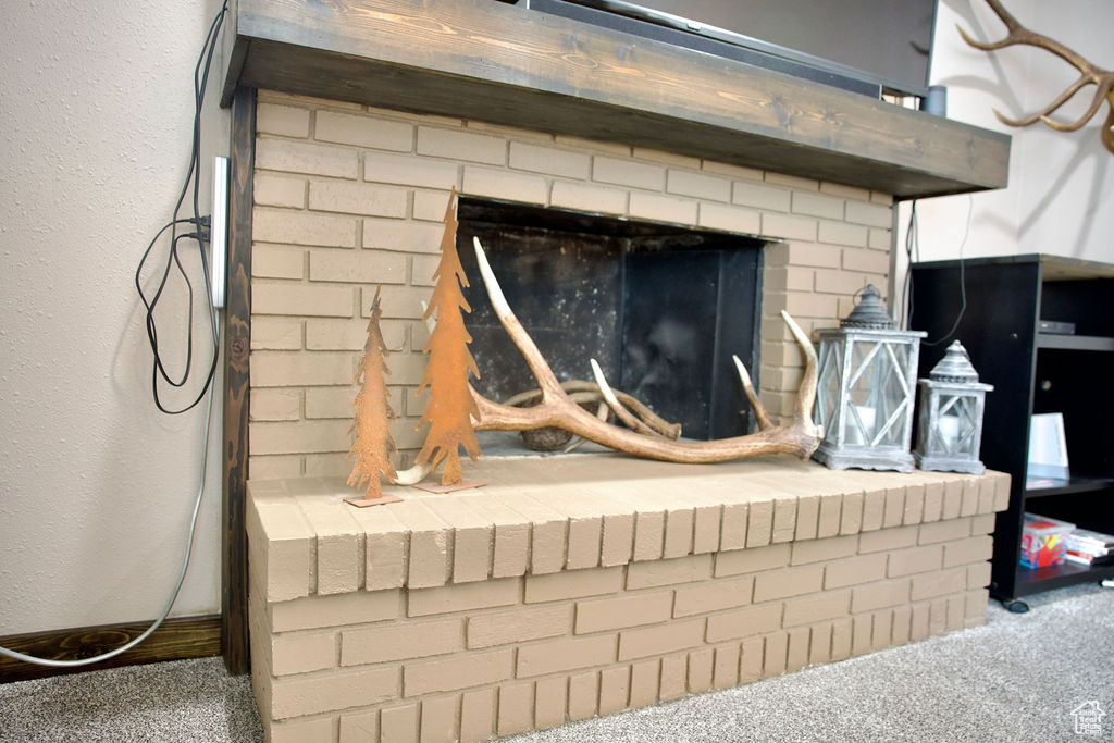 Interior details featuring carpet flooring and a fireplace
