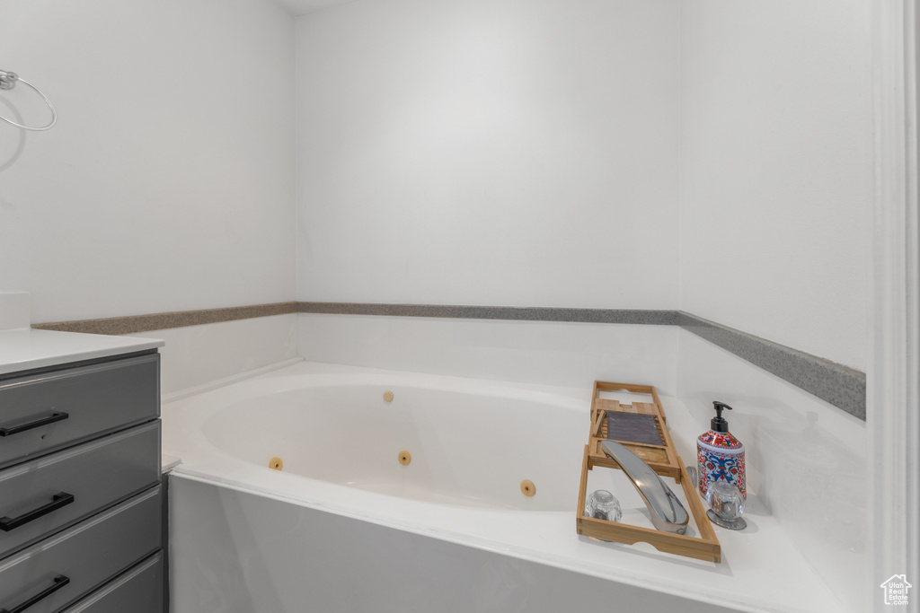 Full bath with a tub with jets