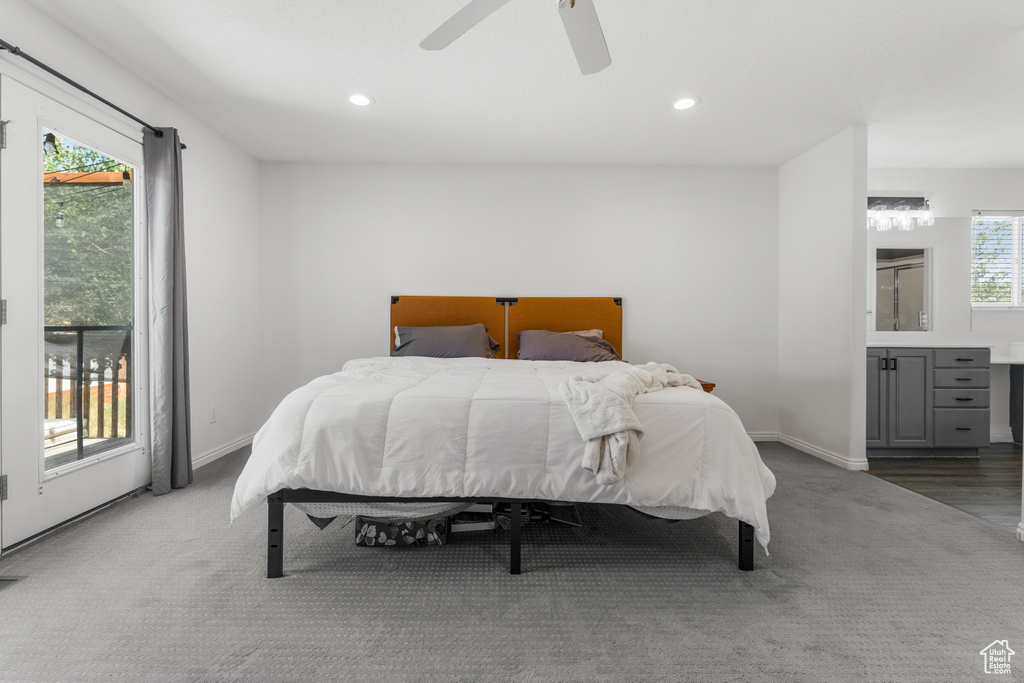 Carpeted bedroom with recessed lighting, baseboards, and ensuite bath