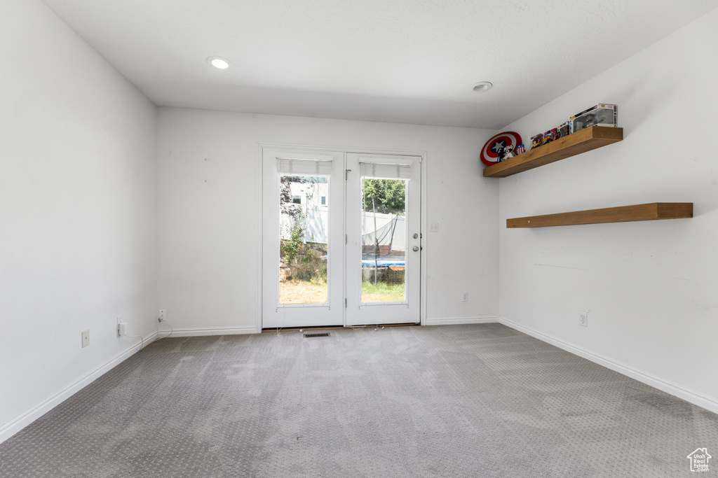 Spare room with baseboards, recessed lighting, carpet, and visible vents