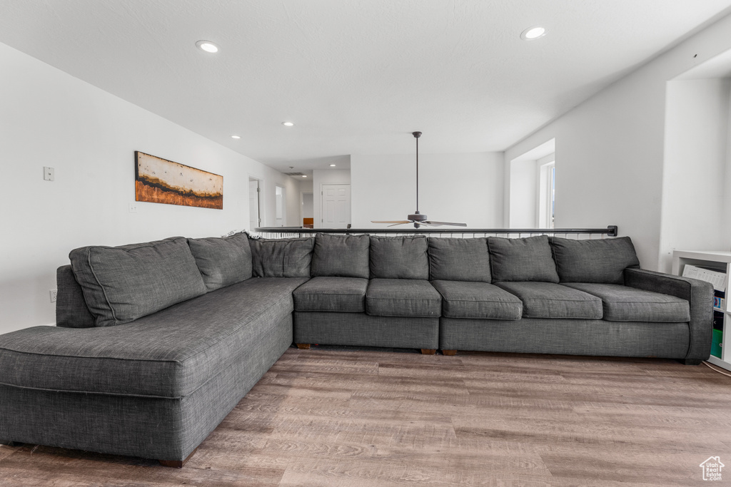 Living room with ceiling fan, recessed lighting, and light wood-style flooring