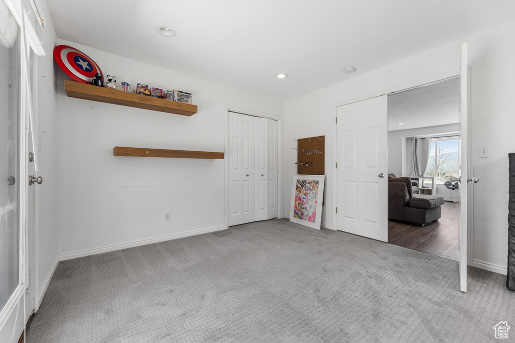 Unfurnished bedroom with carpet floors, recessed lighting, baseboards, and a closet