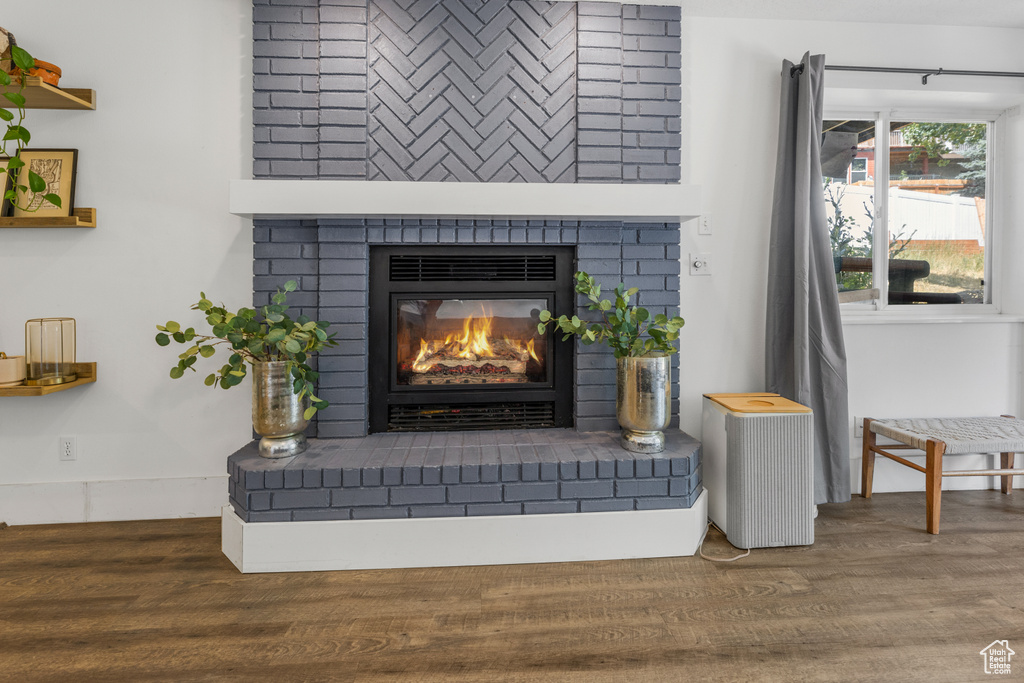 Interior details featuring a brick fireplace and wood finished floors